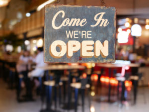 Come In We're Open Sign Hanging From Restaurant Window